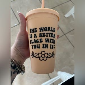 Pastel orange tumbler with a straw